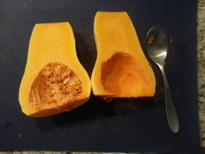 Cut the squash in half and scrape out the seeds with a spoon.